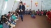 Lilah Salih, a Yazidi woman from a village outside Sinjar in northern Iraq, resettled in the U.S. with her husband in 2017. She is pictured here working Yazidi children when she was in the Sharia refugee camp after the attack on Sinjar.