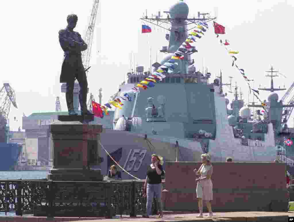 Chinese destroyer Xian is moored at the Neva River embankment in St.Petersburg, Russia, with a sculpture of admiral and explorer Ivan Krusenshtern on the left. The destroyer is there to take part in the Russian Navy Day Parade in Kronshtadt, outside St. Petersburg on July 28.