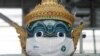 A Thai traditional giant statue wears a protective mask, amid the coronavirus disease (COVID-19) pandemic, at Suvarnabhumi Airport in Bangkok, Thailand Dec. 15, 2020.
