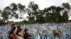 Relatives are seen during a mass burial of people who passed away due to the coronavirus disease, at the Parque Taruma cemetery in Manaus, Brazil.