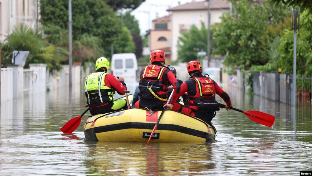 FILE - Firefighters transport food and water to people who are still in their homes after heavy rains hit Italy's Emilia Romagna region, in Lugo, Italy, May 19, 2023. 