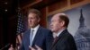 Sen. Jeff Flake, R-Ariz., left, and Sen. Chris Coons, D-Del., talk to reporters after making speeches on the Senate floor calling for a resolution to back the U.S. intelligence community findings that Russia interfered in the 2016 election and calling for other responses to the meddling, on Capitol Hill in Washington, July 19, 2018. 