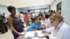 FILE - A doctor assists people looking for treatment for malaria at a health center in San Felix, Venezuela, Nov. 3, 2017. 