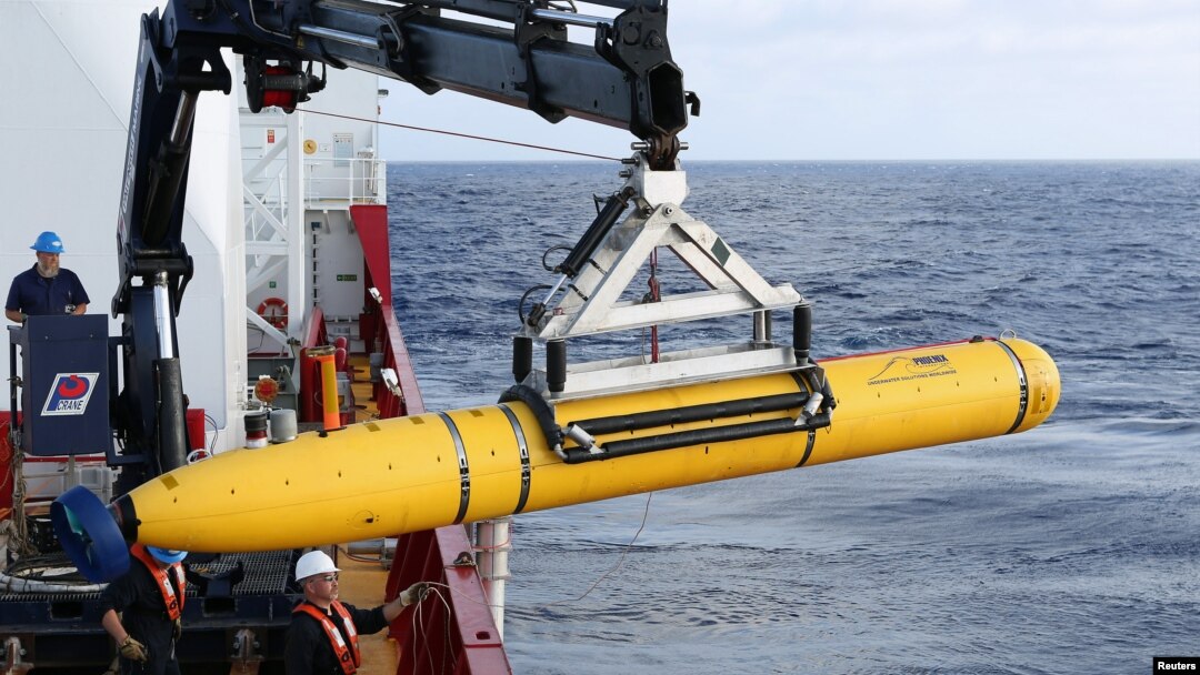 Crew aboard the Australian Defence Vessel Ocean Shield move the U.S. Navy's Bluefin-21 autonomous underwater vehicle into position for deployment in the southern Indian Ocean to look for the missing Malaysia Airlines flight MH370, April 14, 2014.
