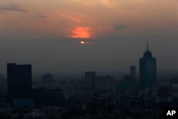 Smog blankets the sky in Mexico City, May 17, 2019. Both lower schools and universities were closed for a third straight day for the pollution alert triggered by smoke from ongoing brush fires combined with the lack of rain.