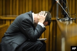 Oscar Pistorius cradles his head in his hands in court on the fifth day of his trial at the high court in Pretoria, South Africa, March 7, 2014.