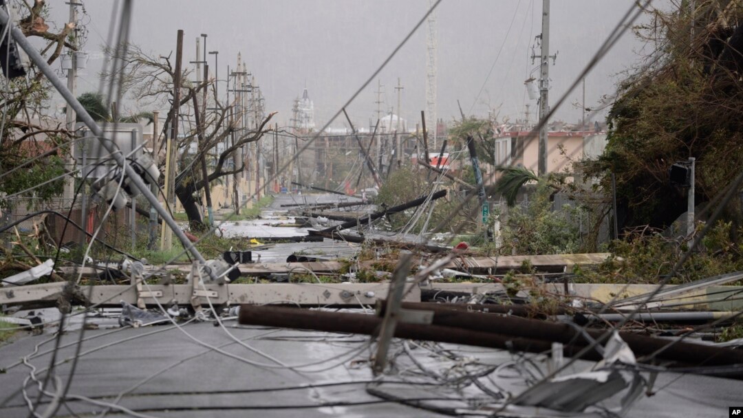 Electricity poles and lines lay toppled on the road after Hurricane Maria hit the eastern region of the island, in Humacao, Puerto Rico, Wednesday, Sept. 20, 2017. (AP Photo/Carlos Giusti)