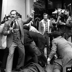 Would-be assassin John Hinckley is wrestled to the ground after he fired his weapon at President Ronald Reagan near a Washington hotel, D.C., March 30, 1981.