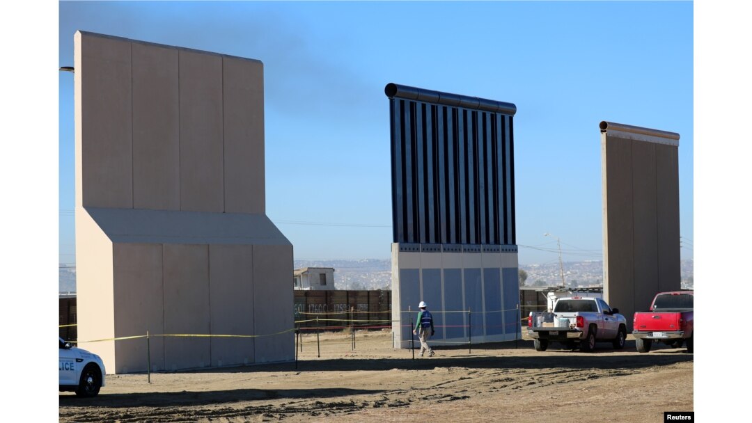 Three of U.S. President Donald Trump's eight border wall prototypes are shown near completion along U.S.- Mexico border in San Diego, California, Oct. 23, 2017.