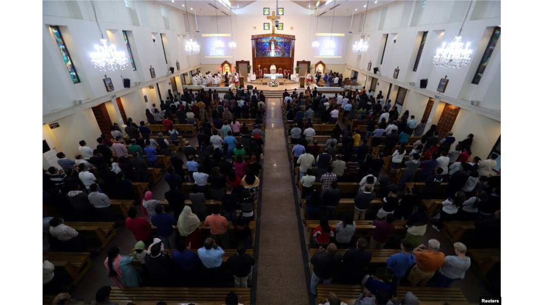 FILE - Worshippers attend their Friday evening Mass at Sacred Heart Catholic Church, as Catholics are awaiting a historic visit by Pope Francis to the United Arab Emirates, in Manama, Bahrain, Jan. 18, 2019.