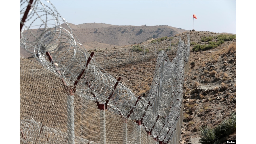 FILE - A view of the border fence outside the Kitton outpost on the border with Afghanistan in North Waziristan, Pakistan, Oct. 18, 2017.