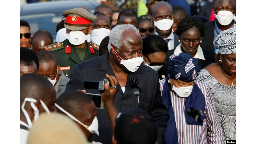 Sierra Leone President Ernest Koroma and Liberian President Ellen Johnson Sirleaf are seen on arrival for the burial of victims of the mudslide, at the Paloko cemetery, in Waterloo, Sierra Leone, Aug. 17, 2017.