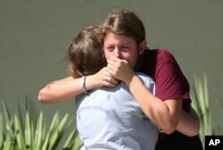 Students grieve outside Pines Trail Center where counselors are present, after Wednesday's mass shooting at Marjory Stoneman Douglas High School in Parkland, Florida, Feb. 15, 2018.
