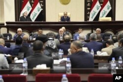 Iraqi Prime Minister Haider al-Abadi, center, attends a session of the Iraqi Parliament, in Baghdad, Iraq, Wednesday, Sept. 27, 2017.