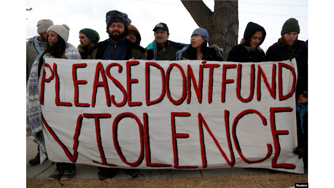 Opponents of the Dakota Access oil pipeline rally outside the Bank of North Dakota in Bismarck, Jan. 31, 2017.