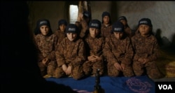 Osama, 13, wears an al-Nusra Front uniform in a camp training youth to fight for the terror group. (Kahtan Hasson for VOA)