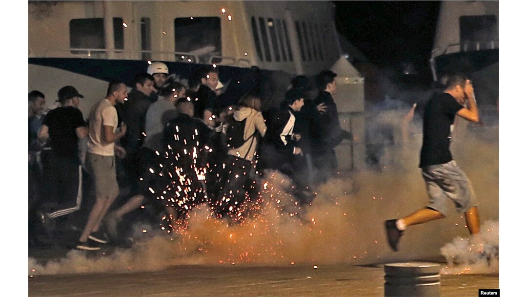 Police disperse revellers at the old port of Marseille after the England v. Russia - Group B match.