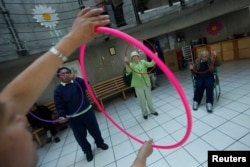 FILE - Patients with Alzheimer's and dementia are seen during a therapy session inside the Alzheimer Foundation in Mexico City.