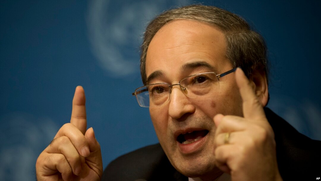 Syrian Deputy Foreign Minister Faisal Makdad gestures during a press briefing at the United Nations headquarters in Geneva, Switzerland, Jan. 26, 2014.