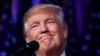 FILE - President-elect Donald Trump smiles as he arrives to speak at an election night rally. Despite Trump’s promises to reopen coal mines, pull out of the Paris climate treaty and roll back environmental regulations, there's only so much the president-elect can do once he begins governing next year.