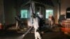 FILE - ervicemen of Belarus Ministry of Defence wearing protective gear disinfect a local hospital in the town of Zaslavl, outside the capital Minsk, Belarus, April 29, 2020