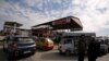 FILE - Cars stand in line at a gasoline station as they wait to fuel up in Aleppo, Syria, April 11, 2019.