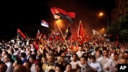 Supporters of the ruling conservative VMRO-DPMNE party rally in front of the Parliament building in Skopje, Macedonia, May 18, 2015. 