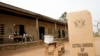 FILE - A sign for Ghana's electoral commission is seen at a polling station in Accra during a previous election.