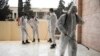 Members of a humanitarian aid agency disinfect Ibn Sina hospital as prevention against coronavirus in Idlib, Syria, March 19, 2020.