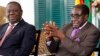 Zimbabwean President Robert Mugabe (R) and Prime Minister Morgan Tsvangirai address a media conference in Harare, January 17, 2013.