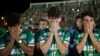 Chapecoense soccer players who did not travel with their team on a flight to Colombia that crashed, mourn during a tribute to the crash victims at Arena Condado stadium in Chapeco, Brazil, Nov. 30, 2016.