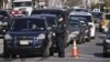 Police direct cars to gas pumps outside a gas station in the Brooklyn borough of New York, November 9, 2012.