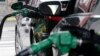 FILE - Gas is pumped into vehicles at a BP gas station in Hoboken, N.J., June 30, 2016. Federal regulators will review strict vehicle fuel efficiency standards finalized days before President Donald Trump took office.