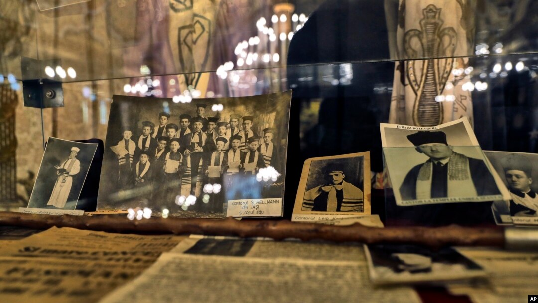 Old pictures showing the daily life of the Romanian Jewish community are on display at the main synagogue in Bucharest, Romania, Jan. 27, 2017, during a commemoration service for those killed 75 years ago.