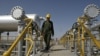 Iranian oil technician Majid Afshari makes his way at the oil separator facilities in Azadegan oil field, near Ahvaz, Iran, (File).