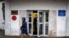 A security guard stands at the door of the building of the editorial office of Novaya Gazeta newspaper in Moscow, Russia, March 15, 2021.