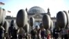 Demonstrators hold balloons in front of the Reichtags building to protest against arms trade, Germany, February 26, 2012.