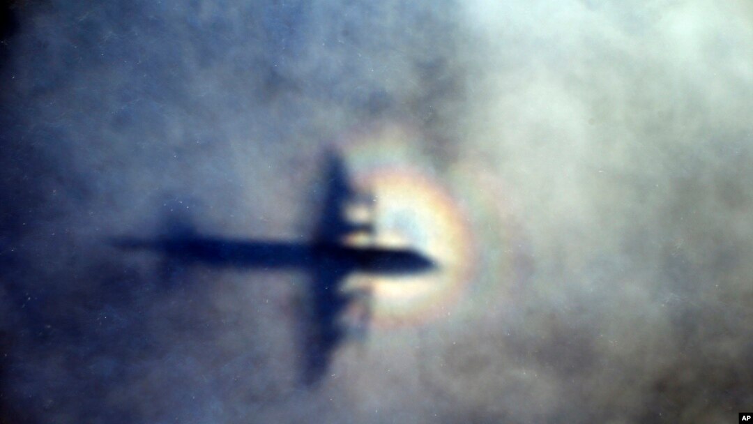 FILE - In this March 31, 2014 file photo, the shadow of a Royal New Zealand Air Force P3 Orion is seen on low level cloud while the aircraft searches for missing Malaysia Airlines Flight MH370.