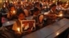 Schoolchildren hold candles and portraits of former South African President Nelson Mandela during a prayer ceremony at a school in the western Indian city of Ahmedabad, Dec. 6, 2013.