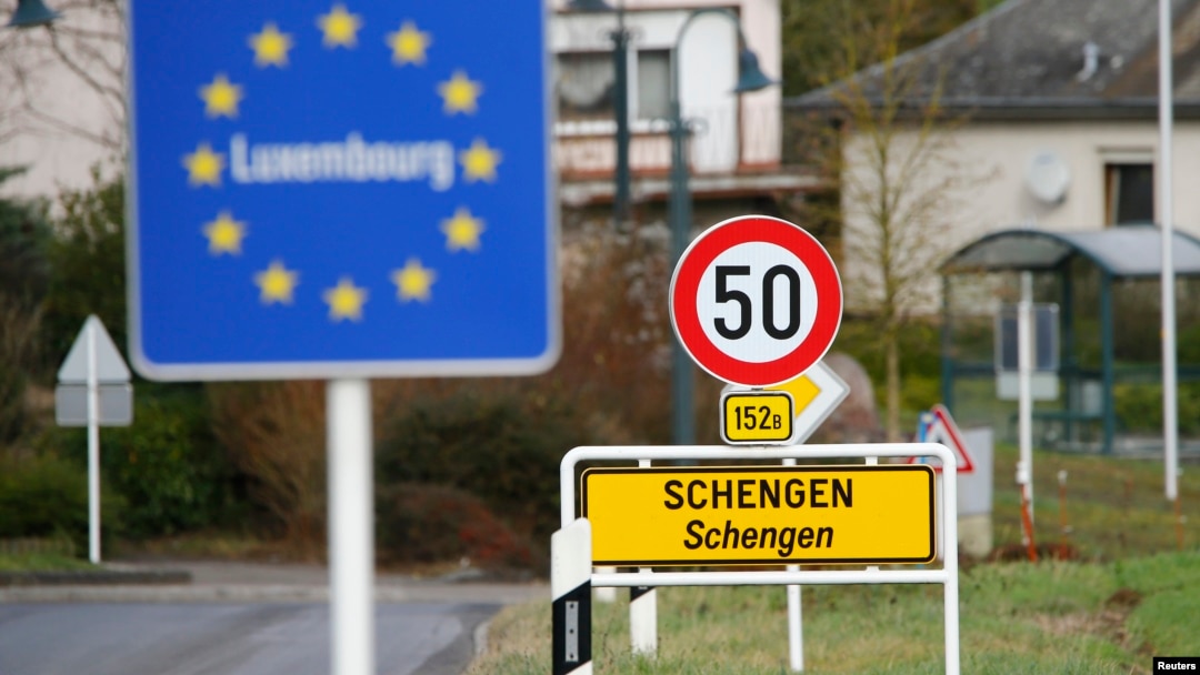 FILE -- A street sign marks the beginning of Schengen, Luxembourg. Schengen Agreement with the goal to illiminate internal border controls was signed there June 14, 1985. The European Union says it won't extend the temporary border controls beyond November. 