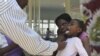 A doctor examines a child suffering from typhoid at a local infectious disease hospital in Harare, Zimbabwe, November15, 2011. 