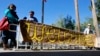 FILE - A sign welcoming Syrian refugees is placed at the entrance to the office of the Arizona governor during a rally at the Arizona Capitol in Phoenix, Nov. 17, 2015. A majority of New York voters are opposed to allowing Syrian refugees, a new poll shows.