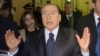 Former Italian Premier Silvio Berlusconi speaks to reporters after a hearing in his Mediaset appeals trial, at Milan's court, Italy, Mar. 1, 2013.