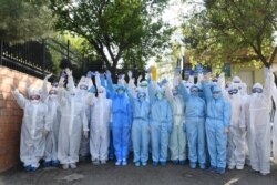 Uzbek medics treating COVID-19 patients pose for a photo, in Tashkent, Uzbekistan, April 2, 2020. (Koronavirusinfouz)