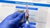 FILE - In this July 27, 2020, photo, a nurse prepares a syringe during a study of a possible COVID-19 vaccine in Binghamton, N.Y.