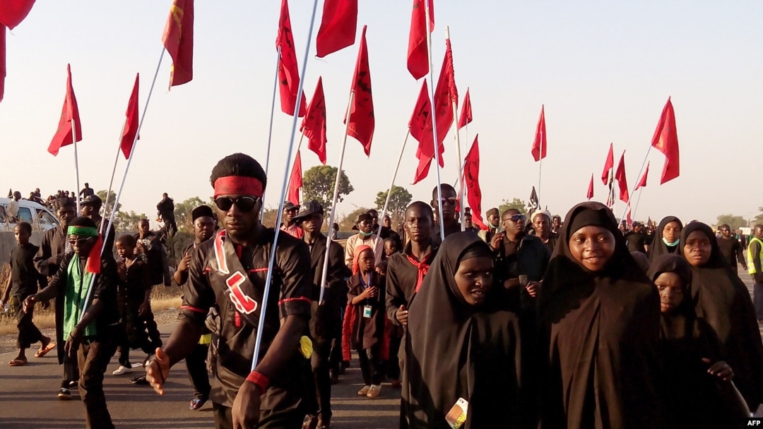 Shiite Muslims march during the 40th anniversary of the Ashura religious ceremony in the village of Dakasoye, northern Nigeria, following a suicide bombing attack that killed at least 21 people near Kano, Nov, 27, 2015.