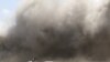 People react as dust rises after explosions hit Aden airport, upon the arrival of the newly-formed Yemeni government in Aden, Yemen, Dec. 30, 2020. 
