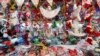 FILE - A vendor arranges Christmas products at her booth in Huaibei, Anhui province, Dec. 11, 2013.