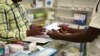 A man buys a face mask at a pharmacy in Kitwe, Zambia, Feb. 6, 2020. The coronavirus has yet to be diagnosed in Africa, but global health authorities are worried about the threat as health workers warn they are not ready to handle an outbreak.
