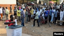 FILE - A man casts his vote at a polling station during presidential elections in Accra, Dec. 7, 2012. Ghana's Inspector General of Police John Kudalor says officers will be ”positively neutral” in the upcoming November general election.